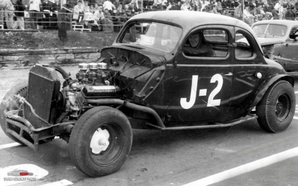 Black and white abstract pattern with concentric circles and wave shapes.