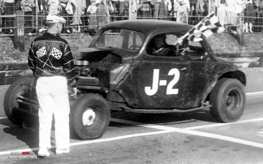 Black and white abstract pattern with concentric circles and wave shapes.