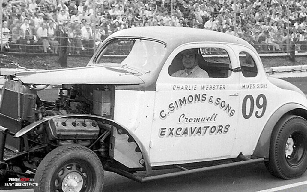 Black and white abstract pattern with concentric circles and wave shapes.