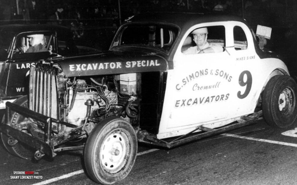 Black and white abstract pattern with concentric circles and wave shapes.