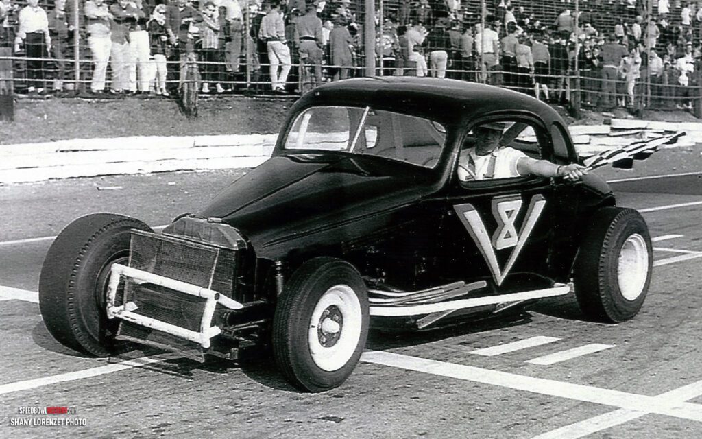 Black and white abstract pattern with concentric circles and wave shapes.