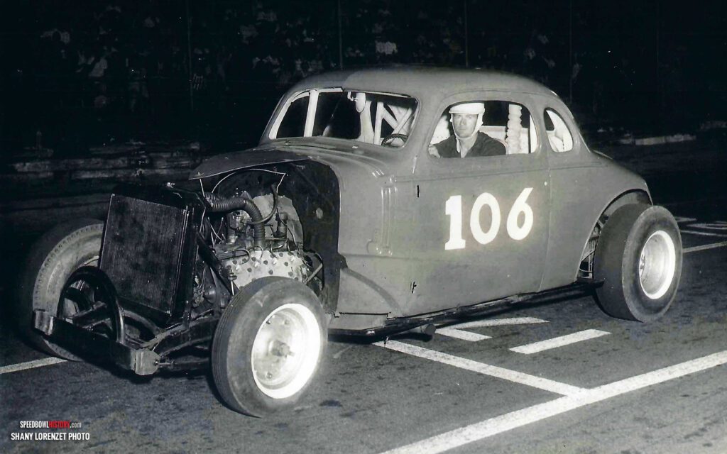 Black and white abstract pattern with concentric circles and wave shapes.