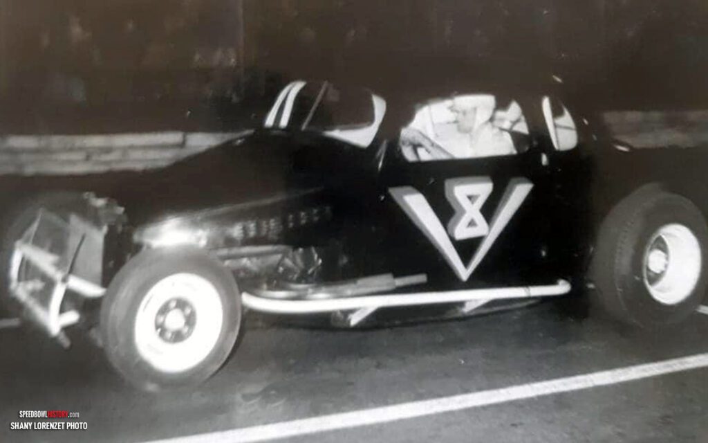 Black and white abstract pattern with concentric circles and wave shapes.