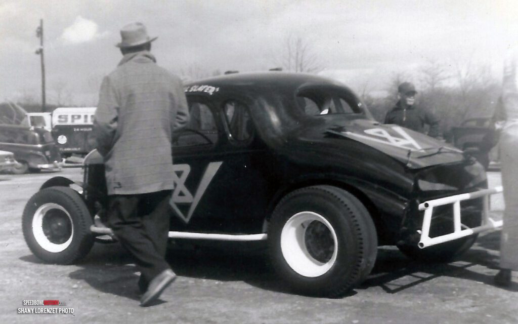 Black and white abstract pattern with concentric circles and wave shapes.