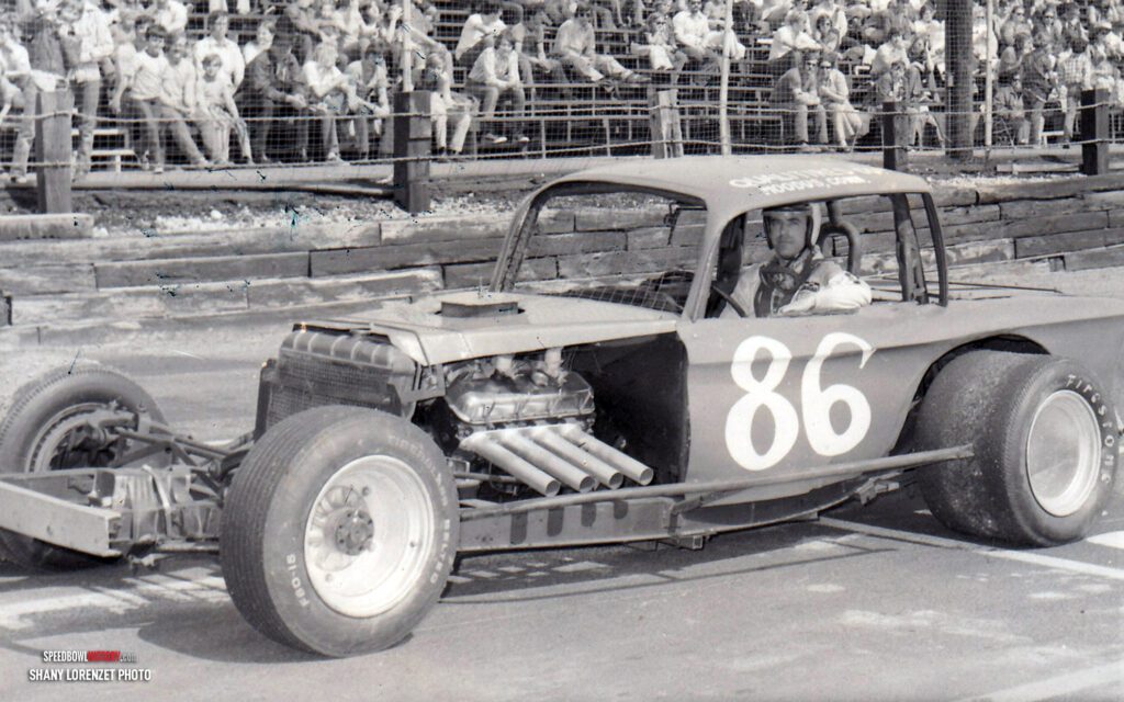 Black and white abstract pattern with concentric circles and wave shapes.