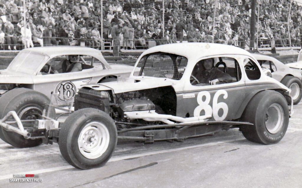 Black and white abstract pattern with concentric circles and wave shapes.