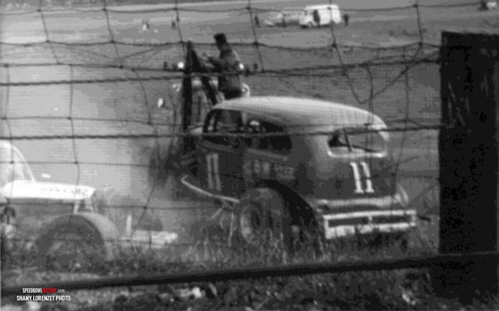 Black and white abstract pattern with concentric circles and wave shapes.