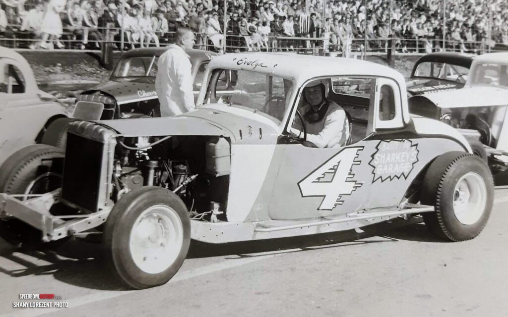 Black and white abstract pattern with concentric circles and wave shapes.