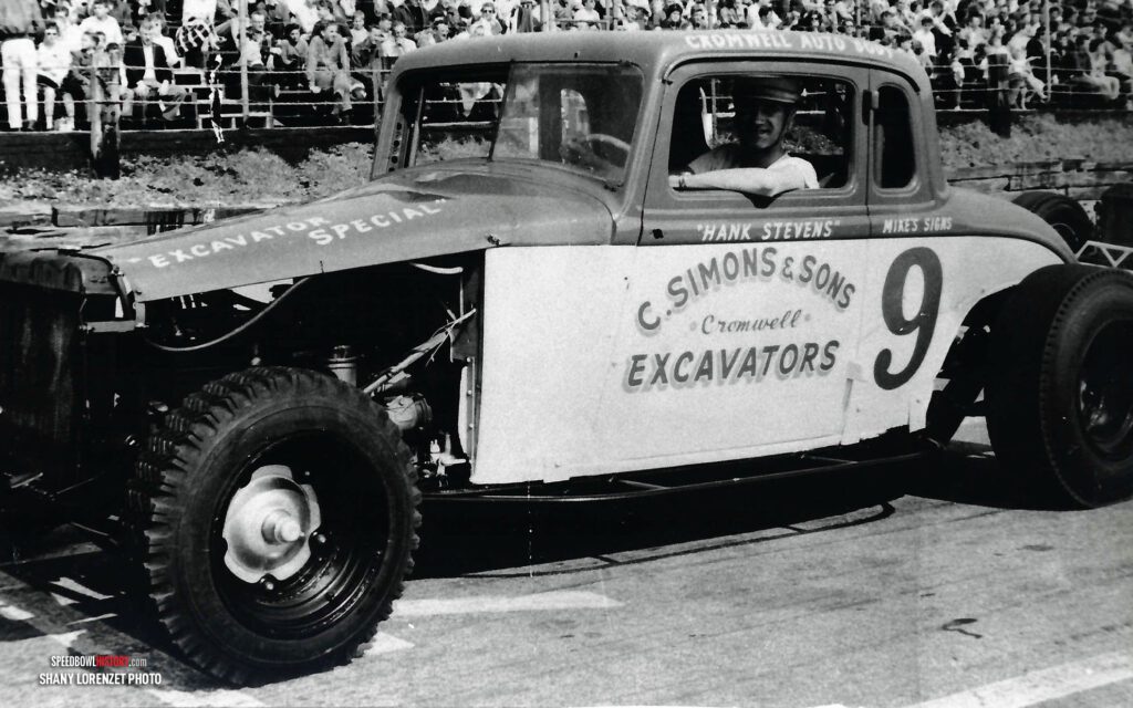 Black and white abstract pattern with concentric circles and wave shapes.