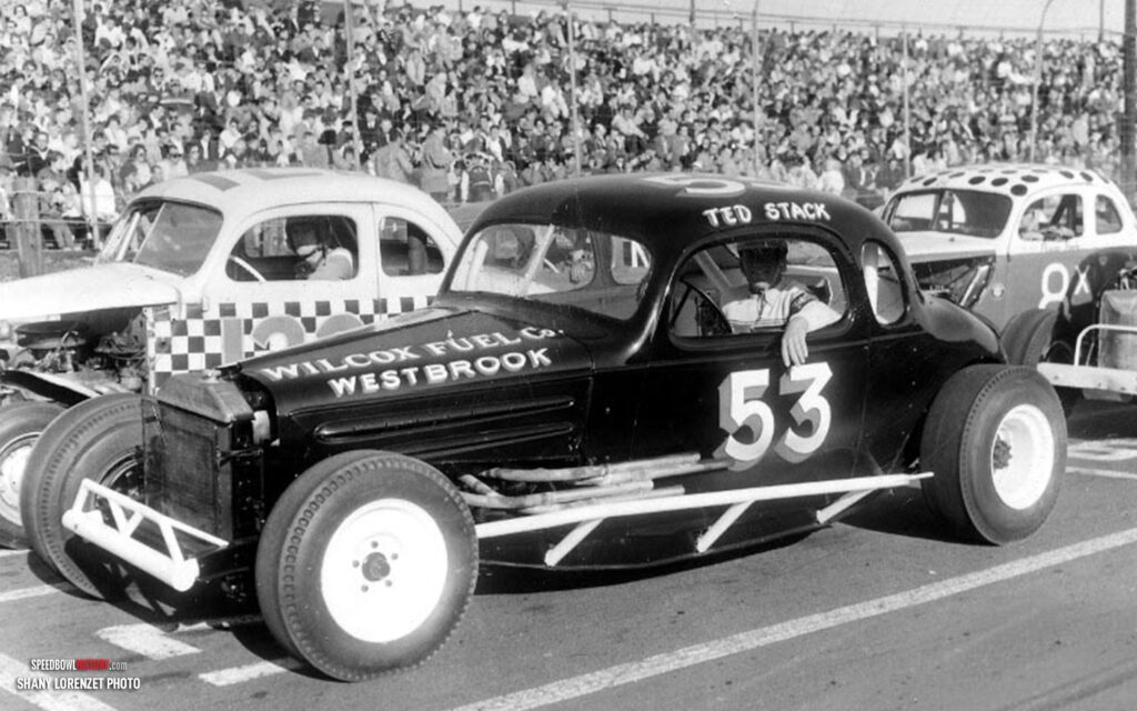 Black and white abstract pattern with concentric circles and wave shapes.