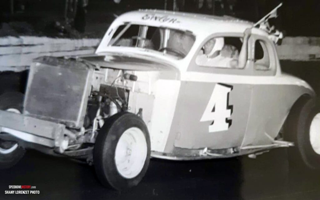 Black and white abstract pattern with concentric circles and wave shapes.