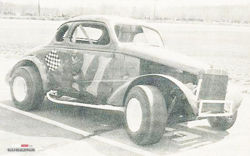 Black and white abstract pattern with concentric circles and wave shapes.