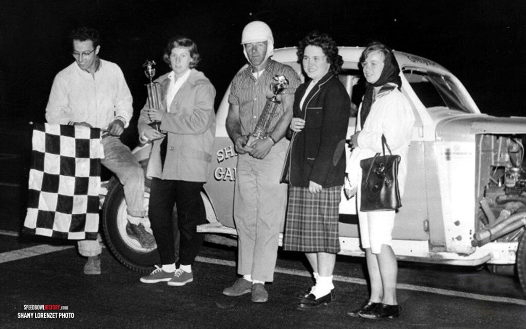 Black and white abstract pattern with concentric circles and wave shapes.