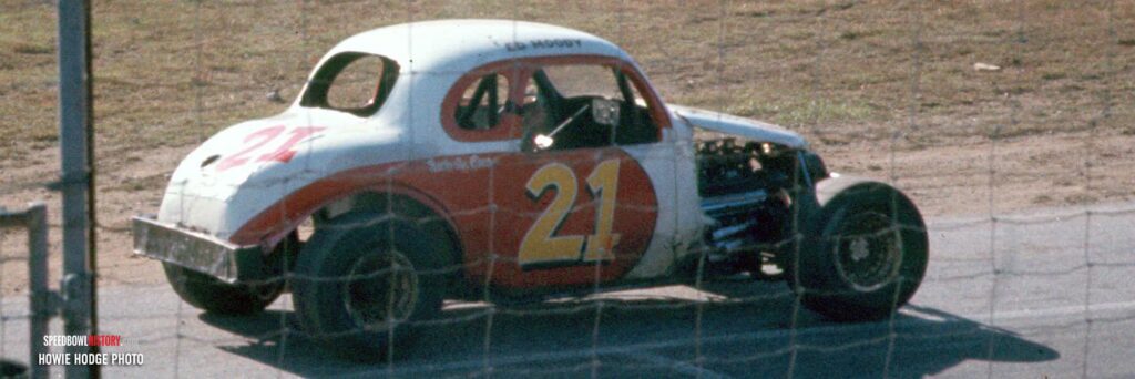 Black and white abstract pattern with concentric circles and wave shapes.