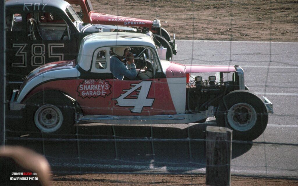 Black and white abstract pattern with concentric circles and wave shapes.