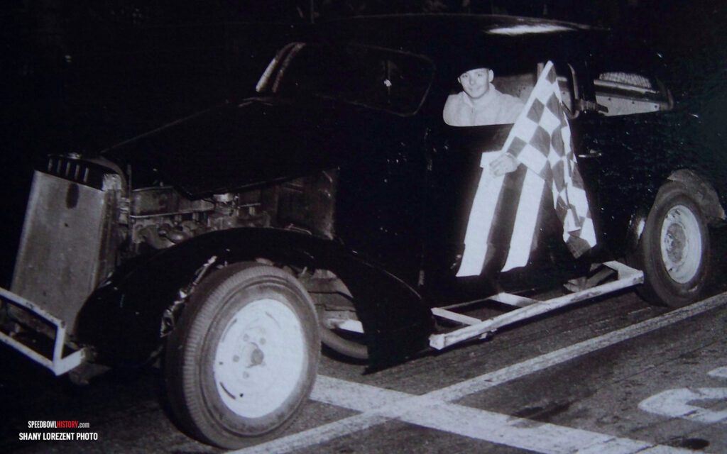 Black and white abstract pattern with concentric circles and wave shapes.