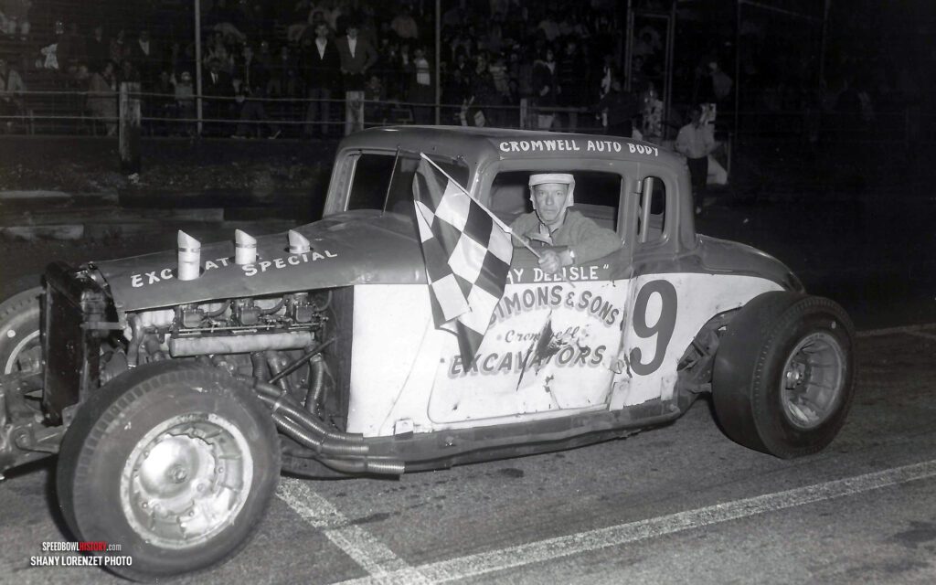 Black and white abstract pattern with concentric circles and wave shapes.
