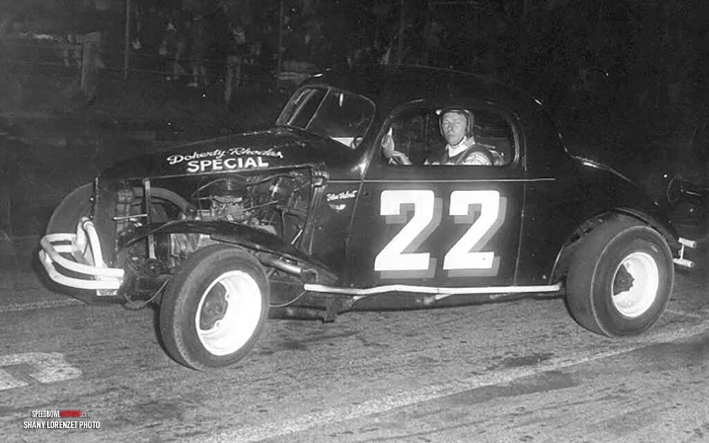 Black and white abstract pattern with concentric circles and wave shapes.