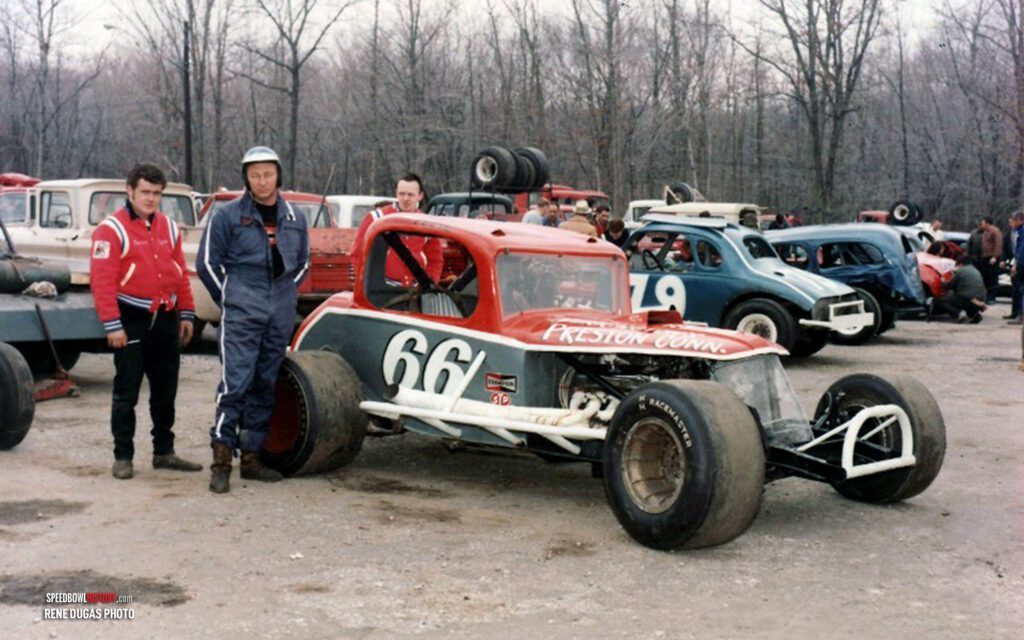 Black and white abstract pattern with concentric circles and wave shapes.