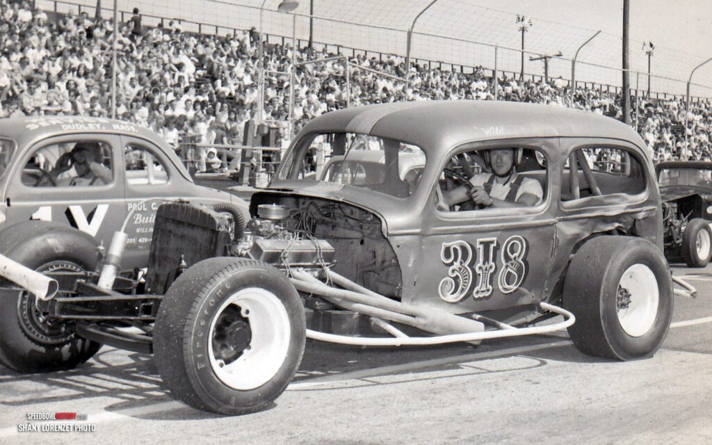 Black and white abstract pattern with concentric circles and wave shapes.