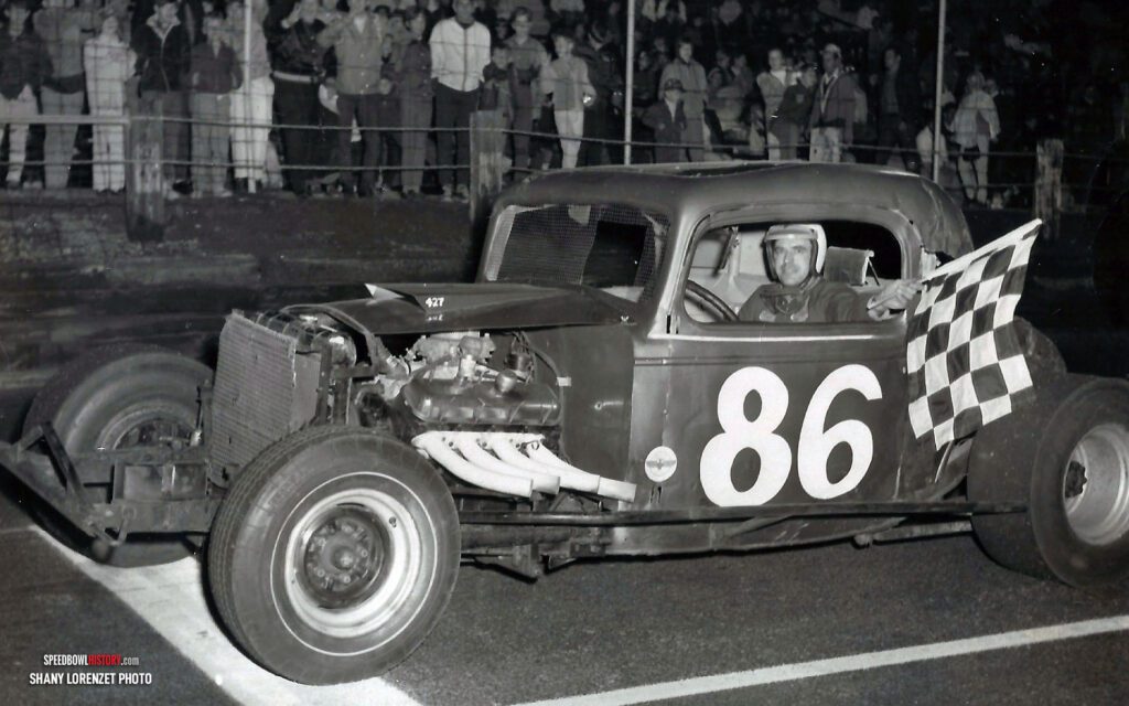 Black and white abstract pattern with concentric circles and wave shapes.