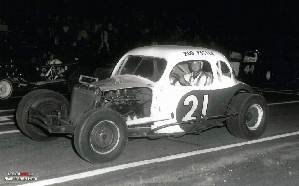 Black and white abstract pattern with concentric circles and wave shapes.