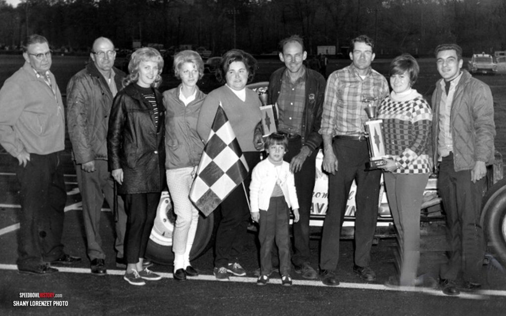 Black and white abstract pattern with concentric circles and wave shapes.