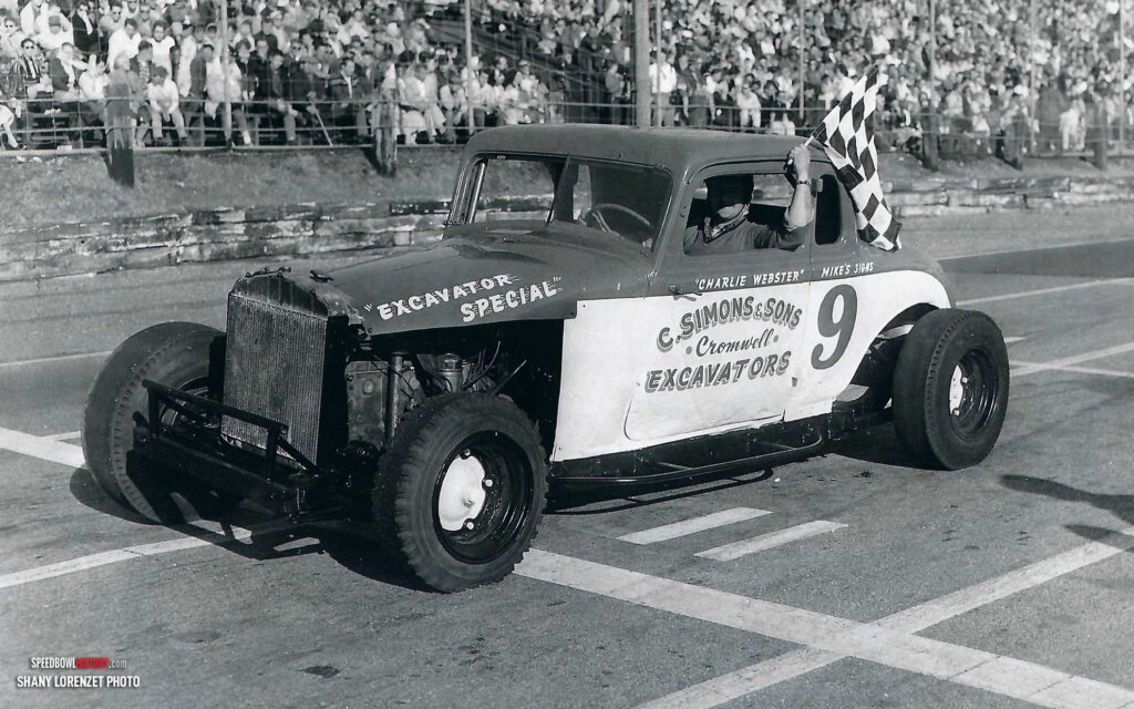 Black and white abstract pattern with concentric circles and wave shapes.