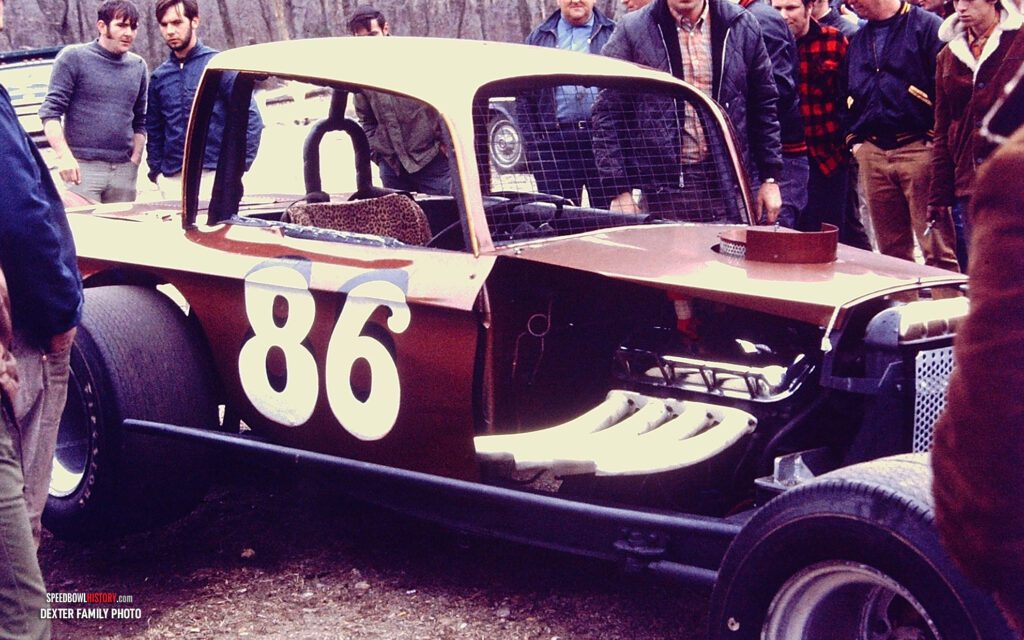 Black and white abstract pattern with concentric circles and wave shapes.