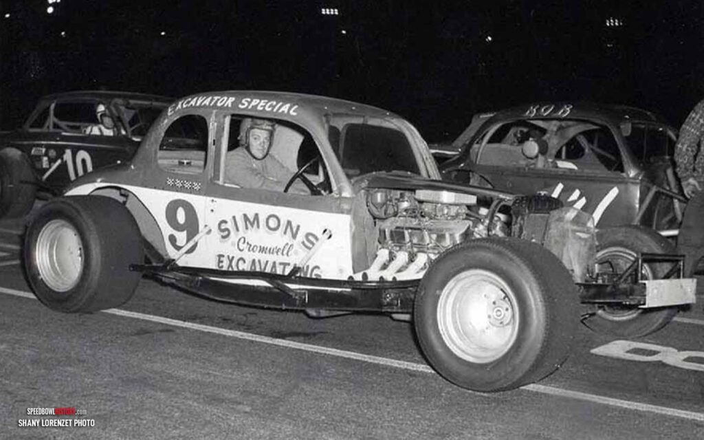 Black and white abstract pattern with concentric circles and wave shapes.