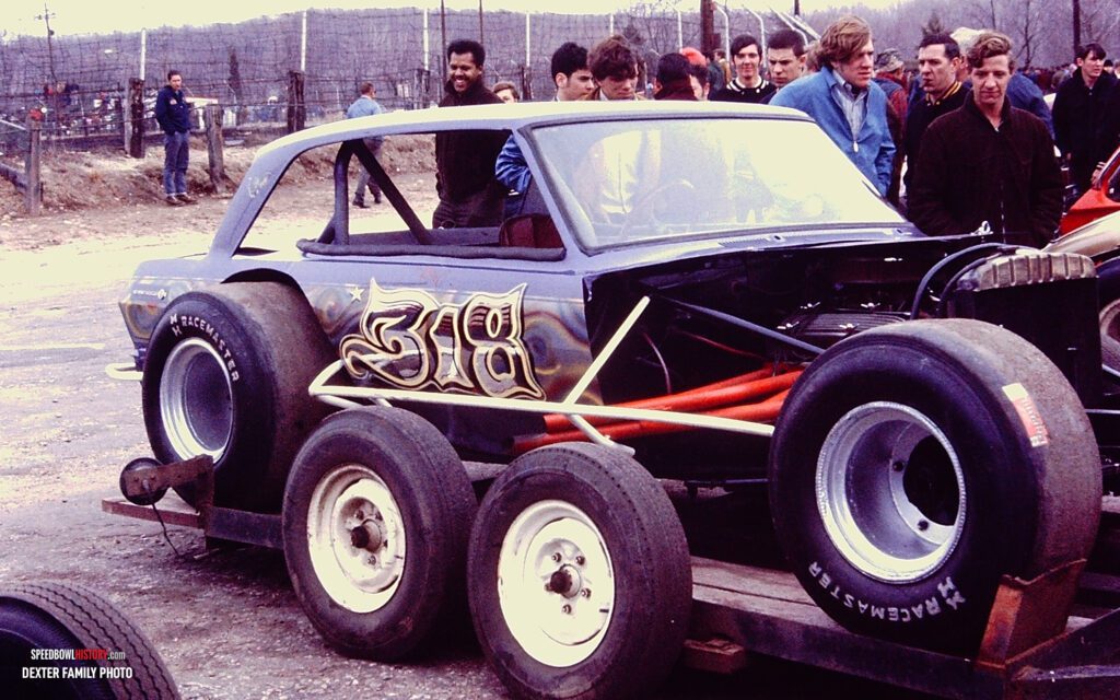 Black and white abstract pattern with concentric circles and wave shapes.