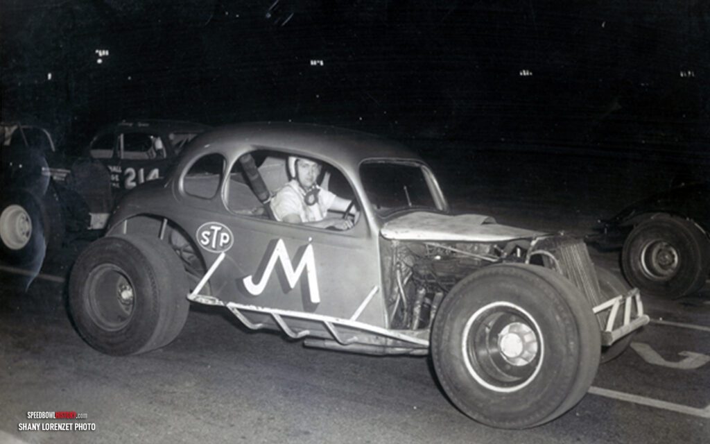 Black and white abstract pattern with concentric circles and wave shapes.