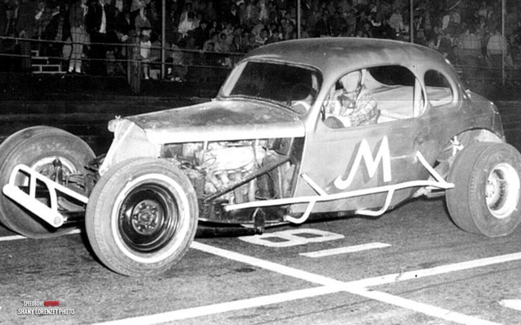 Black and white abstract pattern with concentric circles and wave shapes.