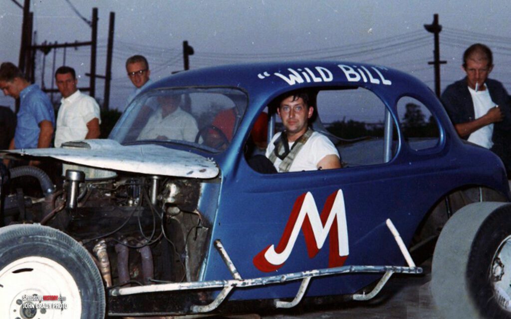 Black and white abstract pattern with concentric circles and wave shapes.