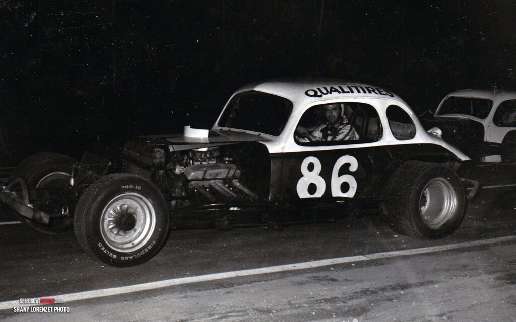 Black and white abstract pattern with concentric circles and wave shapes.