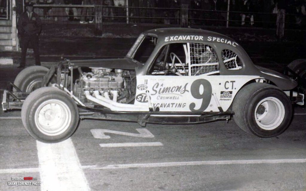 Black and white abstract pattern with concentric circles and wave shapes.