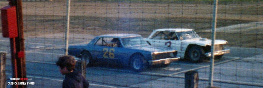 Black and white abstract pattern with concentric circles and wave shapes.