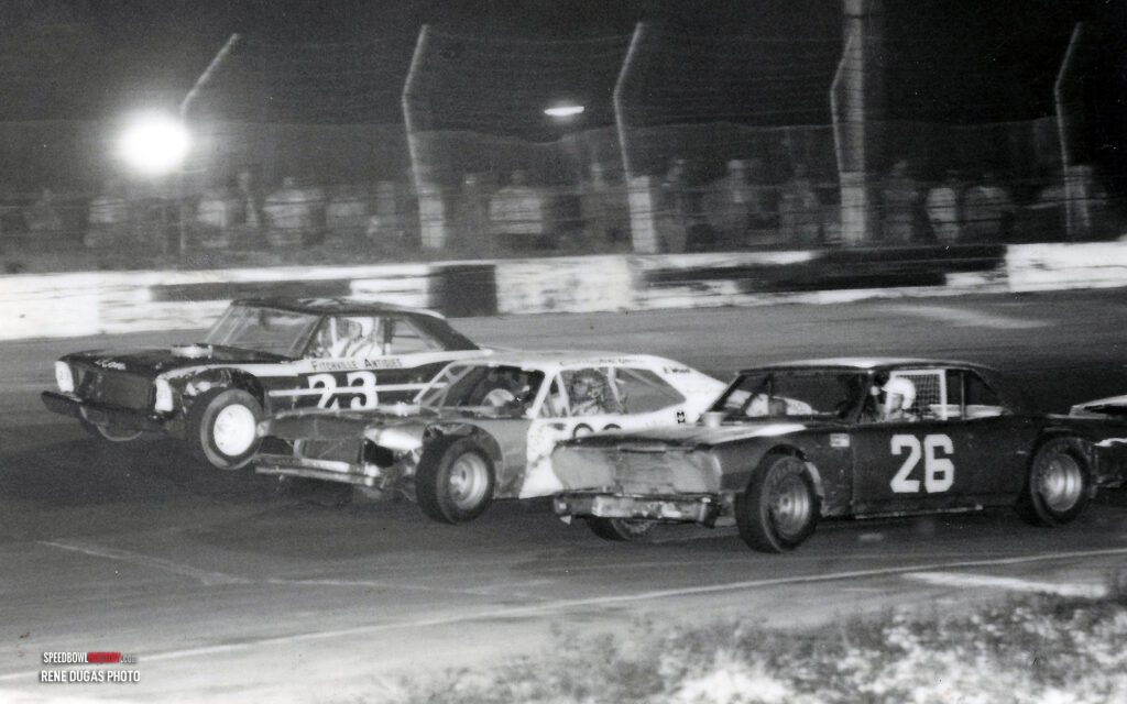 Black and white abstract pattern with concentric circles and wave shapes.