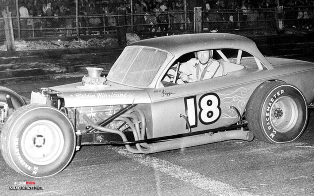 Black and white abstract pattern with concentric circles and wave shapes.