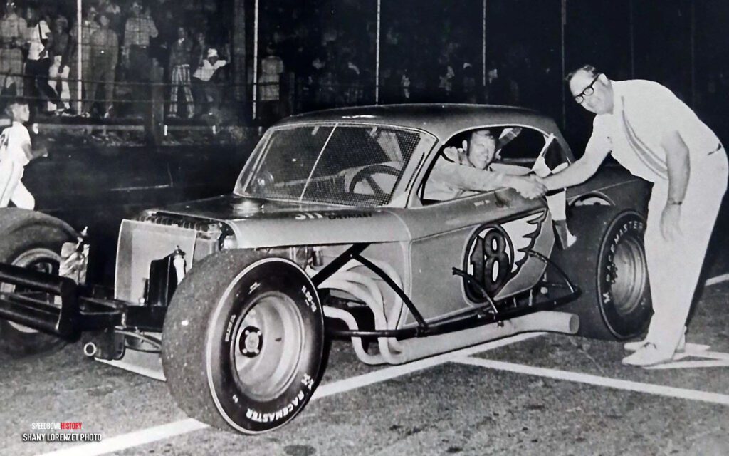 Black and white abstract pattern with concentric circles and wave shapes.