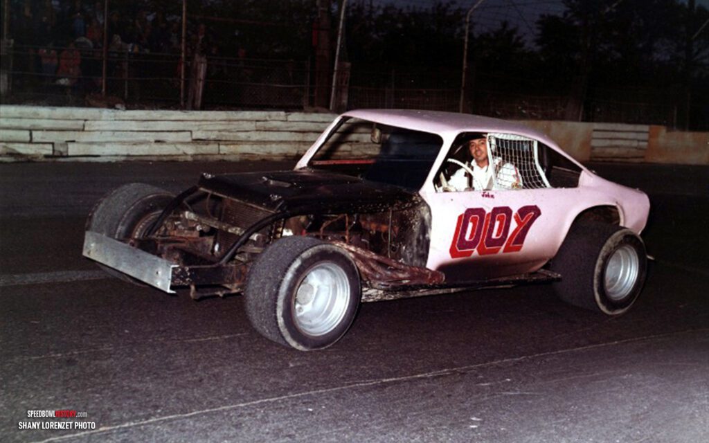 Black and white abstract pattern with concentric circles and wave shapes.