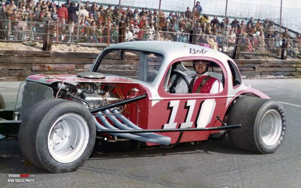 Black and white abstract pattern with concentric circles and wave shapes.