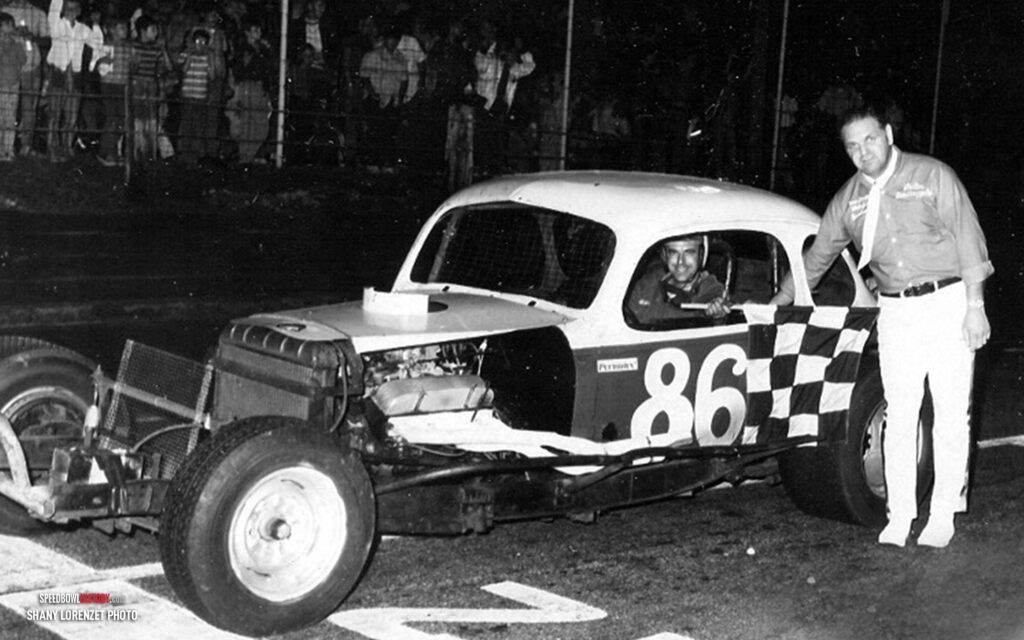 Black and white abstract pattern with concentric circles and wave shapes.