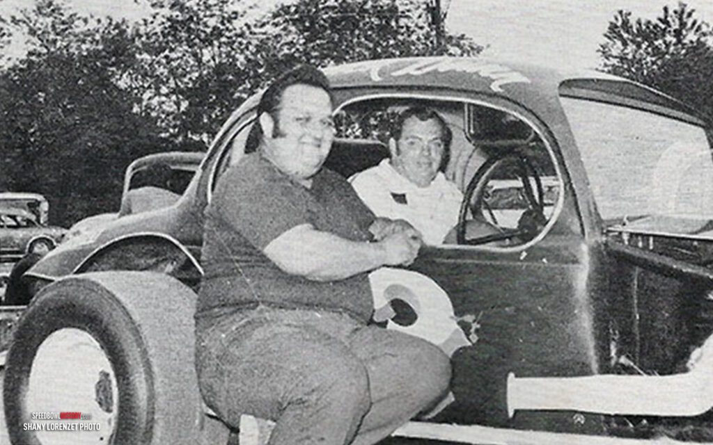 Black and white abstract pattern with concentric circles and wave shapes.