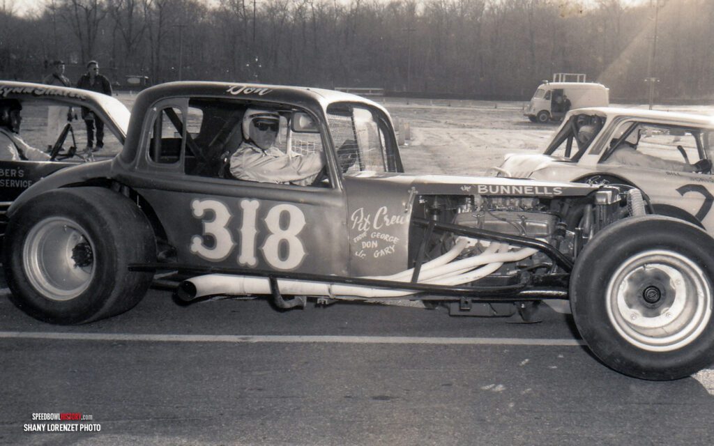 Black and white abstract pattern with concentric circles and wave shapes.