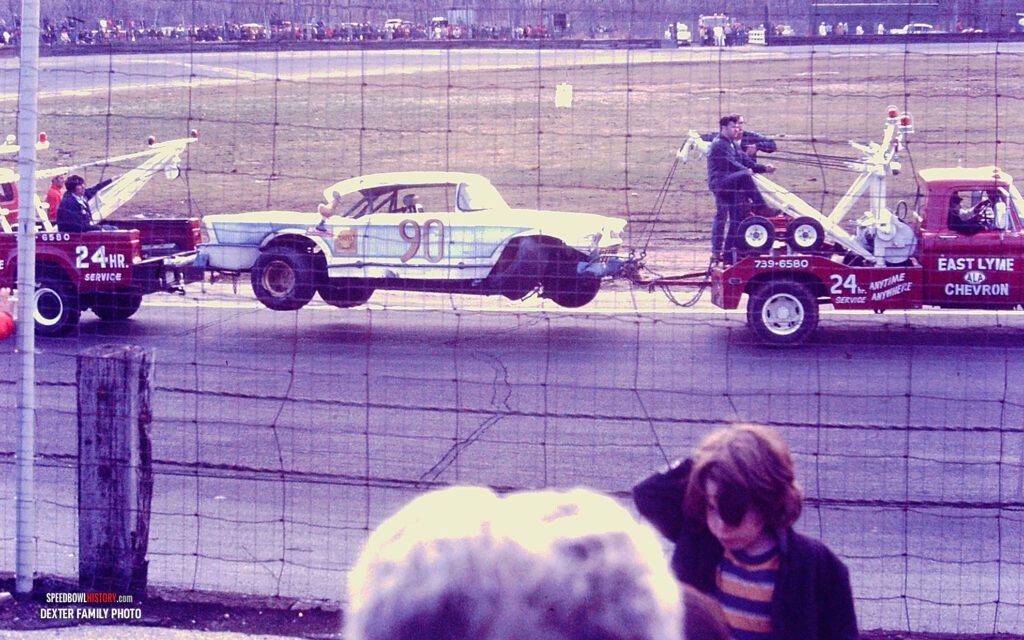 Black and white abstract pattern with concentric circles and wave shapes.