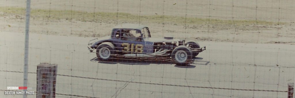 Black and white abstract pattern with concentric circles and wave shapes.