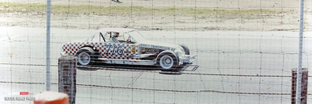 Black and white abstract pattern with concentric circles and wave shapes.