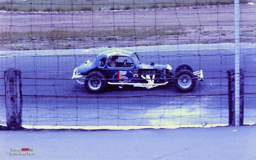 Black and white abstract pattern with concentric circles and wave shapes.