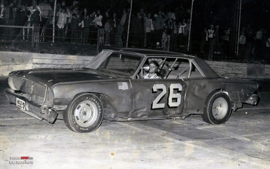 Black and white abstract pattern with concentric circles and wave shapes.